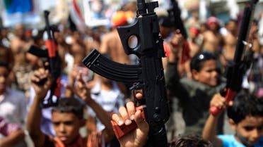 Children hold up toy guns during a march with anti-government protesters to demand the ouster of Yemen's President Ali Abdullah Saleh in the southern city of Taiz November 9, 2011. REUTERS/Khaled Abdullah (YEMEN - Tags: POLITICS CIVIL UNREST)