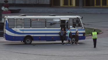 Three hostages walk out of a seized passenger bus in the city of Lutsk, Ukraine July 21, 2020. (Reuters)