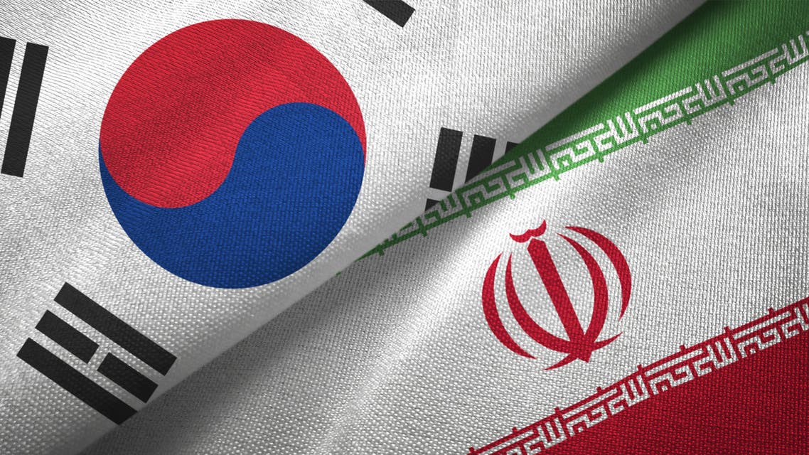 Iran and South Korea two flags together textile cloth fabric texture stock photo