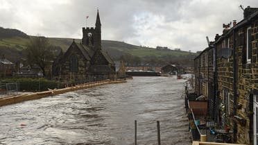 Newly constructed flood defenses are seen beside the River Calder in Mytholmroyd, northern England, on February 9, 2020. (AFP)