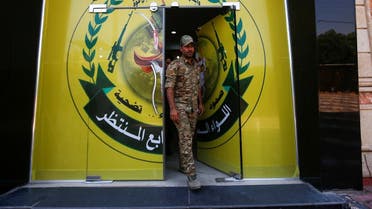 A member of Iraqi Popular Mobilisation Unit (PMU) militias walks out from the headquarters of the seventh brigade in Basra. (File photo: Reuters)