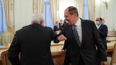 Russian Foreign Minister Sergei Lavrov and his Iranian counterpart Mohammad Javad Zarif greet each other, in Moscow, on July 21, 2020. (AFP)