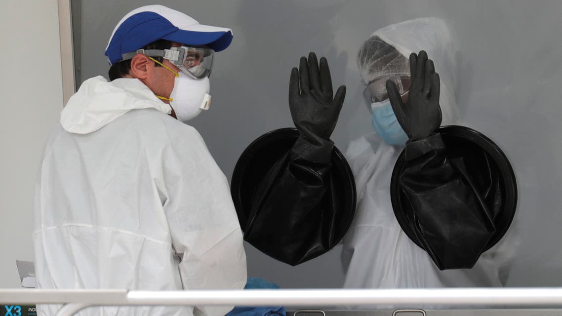 Health care workers work at a walk-up COVID-19 testing site during the coronavirus pandemic, Friday, July 17, 2020, in Miami Beach, Fla. The mobile testing truck is operated by Aardvark Mobile Health, which has partnered with the Florida Division of Emergency Management. People getting tested are separated from nurses via a glass pane. (AP Photo/Lynne Sladky)