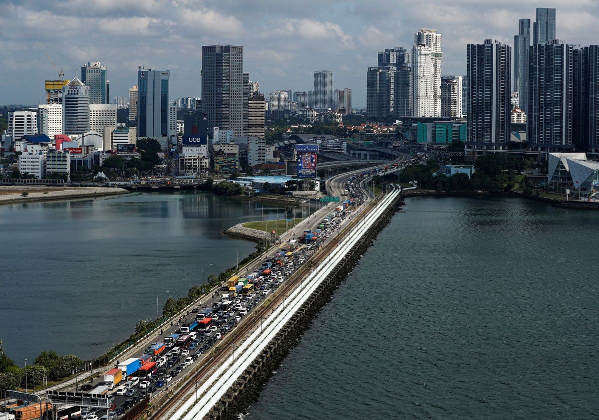 Commuters take the Woodlands Causeway to Singapore from Johor a day before Malaysia imposes a lockdown on travel due to the coronavirus outbreak in Singapore on March 17, 2020. (Reuters)