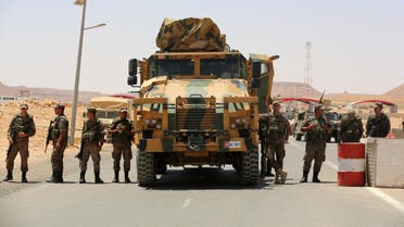 Tunisian army soldiers gather on July 12, 2020, at the border post with neighbouring Libya near the southern town of Dehiba, during a protest by Tunisians expressing their anger after the death earlier this week of a young man who according to demonstrators was killed by the military, 