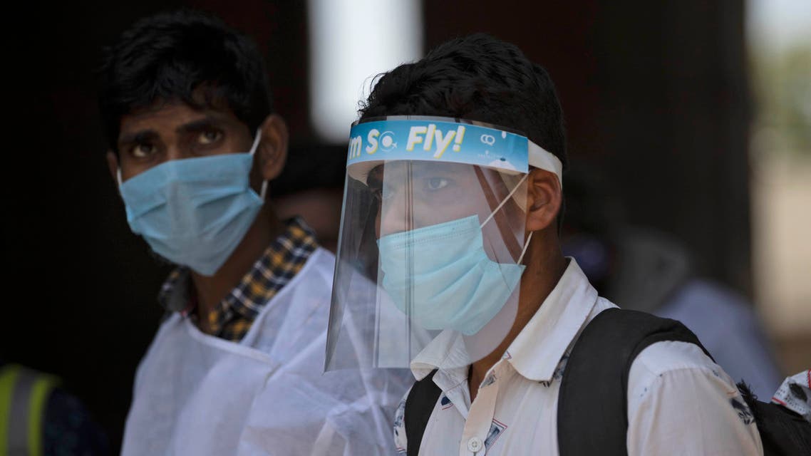 Passengers who arrived from other states of the country walk to be quarantined, outside a quarantine center in Srinagar, Indian controlled Kashmir on July 7, 2020. (AP)
