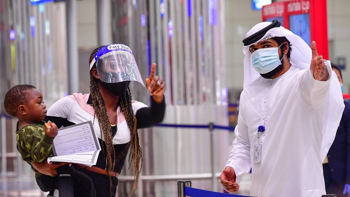A tourist receives instruction at Dubai airport in the United Arab Emirates on July 8, 2020. (AFP)
