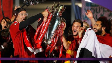 Liverpool manager Juergen Klopp, Adam Lallana and Mohamed Salah celebrate with the trophy after winning the Premier League. (Reuters)