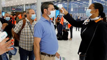A stewardess takes the body temperature of a man at Paris-Orly Airport  following the coronavirus outbreak in France. (File photo: Reuters)
