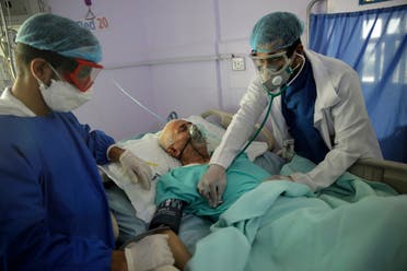 Medical workers attend to a COVID-19 patient in an intensive care unit at a hospital in Sana'a, Yemen. (File photo: AP)
