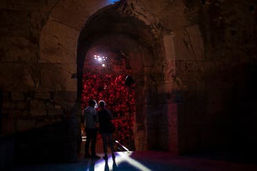 A Steward wearing a plastic visor stands at a gate of the Odeon of Herodes Atticus in Athens, during a concert. (AP)