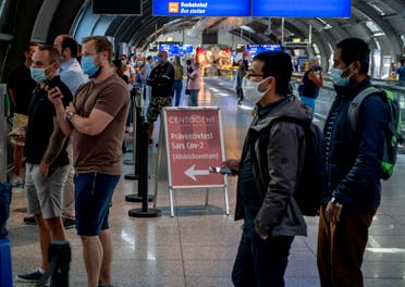 Dozens of passengers from various countries queue at the Centogene test center for a Covid-19 test at the airport in Frankfurt, Germany on July 24, 2020. (AP)