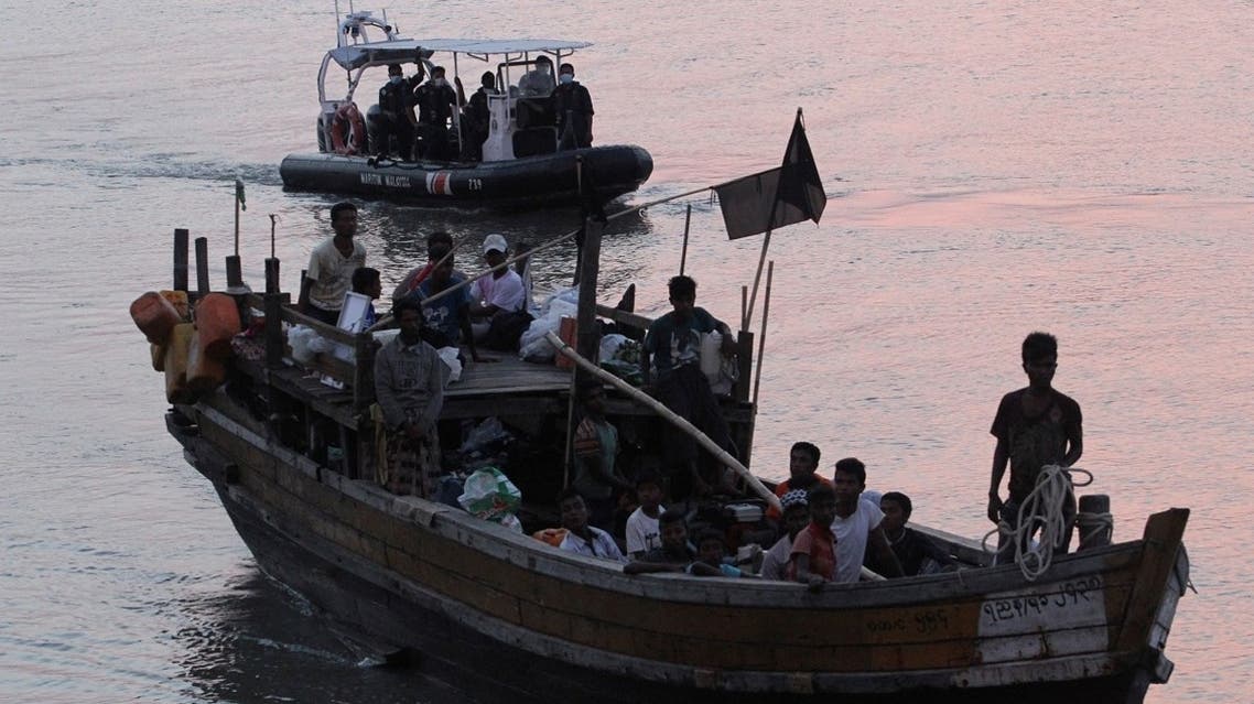 File photo of Rohingya refugees who were intercepted by Malaysian Maritime Enforcement Agency off Langkawi island, are escorted in their boat as they are handed over to immigration authorities, at the Kuala Kedah ferry jetty in Malaysia (Reuters).