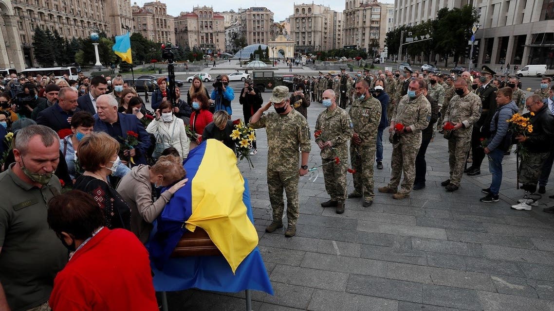 People pay their respects to Taras Matviyiv, a Ukrainian serviceman killed on July 10 in the fighting against pro-Russian separatists in the country's east, during a memorial service at the Independence Square in central Kyiv, Ukraine, on July 14, 2020. (Reuters)