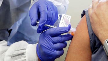 In this March 16, 2020 file photo, a subject receives a shot in the first-stage safety study clinical trial of a potential vaccine by Moderna for COVID-19, in Seattle. (AP)