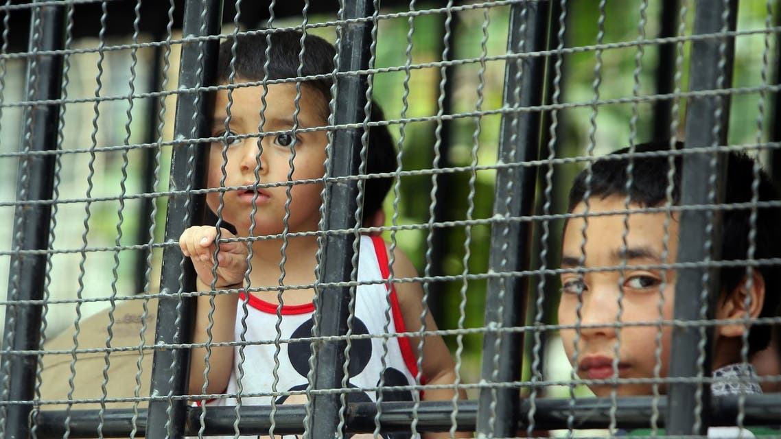 Children, part of a group of asylum seekers thought to be from China's Uighur minority, sit in a truck in Songkhla, southern Thailand on March 15, 2014. (AP)