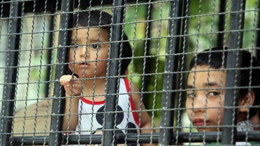 Children, part of a group of asylum seekers thought to be from China's Uighur minority, sit in a truck in Songkhla, southern Thailand on March 15, 2014. (AP)