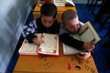 Uighur refugee boys read the Koran where they are housed in a gated complex in the central city of Kayseri, Turkey, February 11, 2015. (File photo: AP)