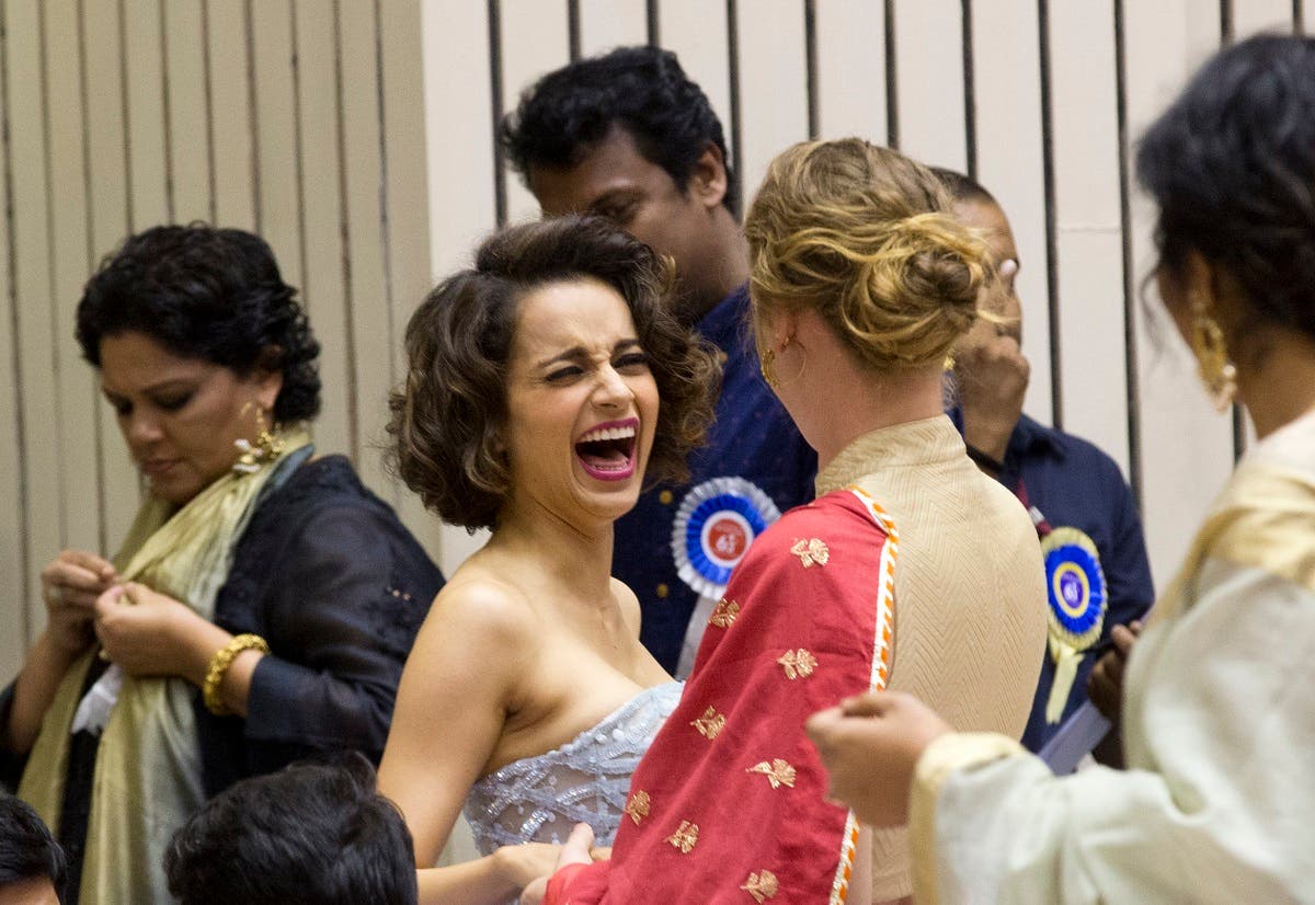 File photo of Bollywood actor Kangana Ranaut (center), gestures as she interacts with an unidentified person during the national film awards presentation ceremony in New Delhi, India. (AP)