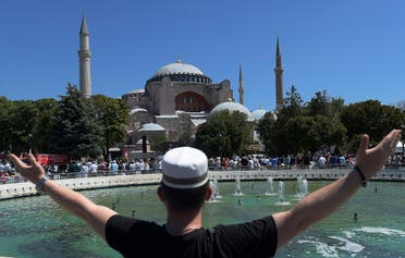 A youth gestures as he waits at the historic Sultanahmet district of Istanbul, outside the Byzantine-era Hagia Sophia on July 24, 2020. (AP)