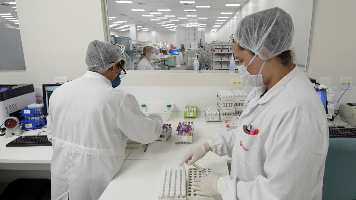 Employees at the Hermes Pardini laboratory work on the coronavirus disease (COVID-19) testing with PCR amplification, in Vespasiano, near Belo Horizonte, Brazil, July 23, 2020. Picture taken July 23, 2020. REUTERS/Washington Alves