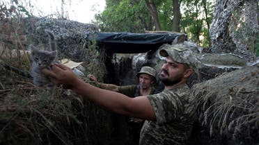 Ukrainian servicemen are seen at a position on the front line near the town of Novotoshkivske in Luhansk region, Ukraine, on July 26, 2020.  (Reuters)
