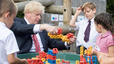 Britain’s Prime Minister Boris Johnson plays with toys as students look on during a visit to The Discovery School in Kent, Britain, on July 20, 2020. (Reuters)