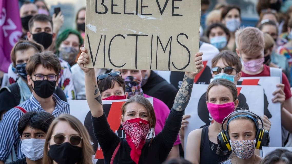A protester holds a banner reading Belive Victims as she takes part in a protest against the Polish government plans to withdraw from the Istanbul Convention on prevention and combatting of home violence, in Warsaw, Poland, on July 24, 2020. (AFP)