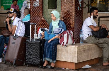 Moroccans gather in the “Ouled Ziane” bus station in Casablanca on July 27 ,2020 to leave the city before travel restrictions are imposed by authorities to smother a new outbreak of the novel coronavirus. (AFP)