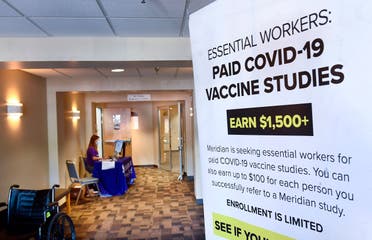 A poster is displayed in the entrance way looking for volunteers as the world's biggest study of a possible COVID-19 vaccine, developed by the National Institutes of Health and Moderna Inc., gets underway on July 27, 2020, in Binghamton, N.Y. (AP)