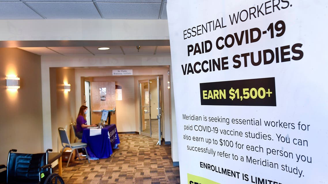 A poster is displayed in the entrance way looking for volunteers as the world's biggest study of a possible COVID-19 vaccine, developed by the National Institutes of Health and Moderna Inc., gets underway Monday, July 27, 2020, in Binghamton, N.Y. (AP Photo/Hans Pennink)