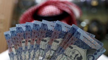 A Saudi money changer displays Saudi Riyal banknotes at a currency exchange shop in Riyadh, Saudi Arabia, July 27, 2017. (Reuters)