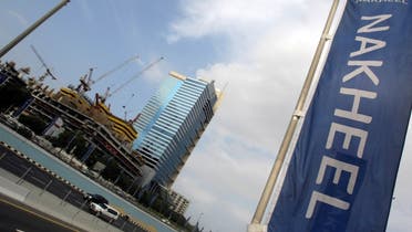A file photo shows a banner of Dubai's property giant Nakheel flutters near construction sites and skyscrapers in the Gulf emirate of Dubai. (AFP)