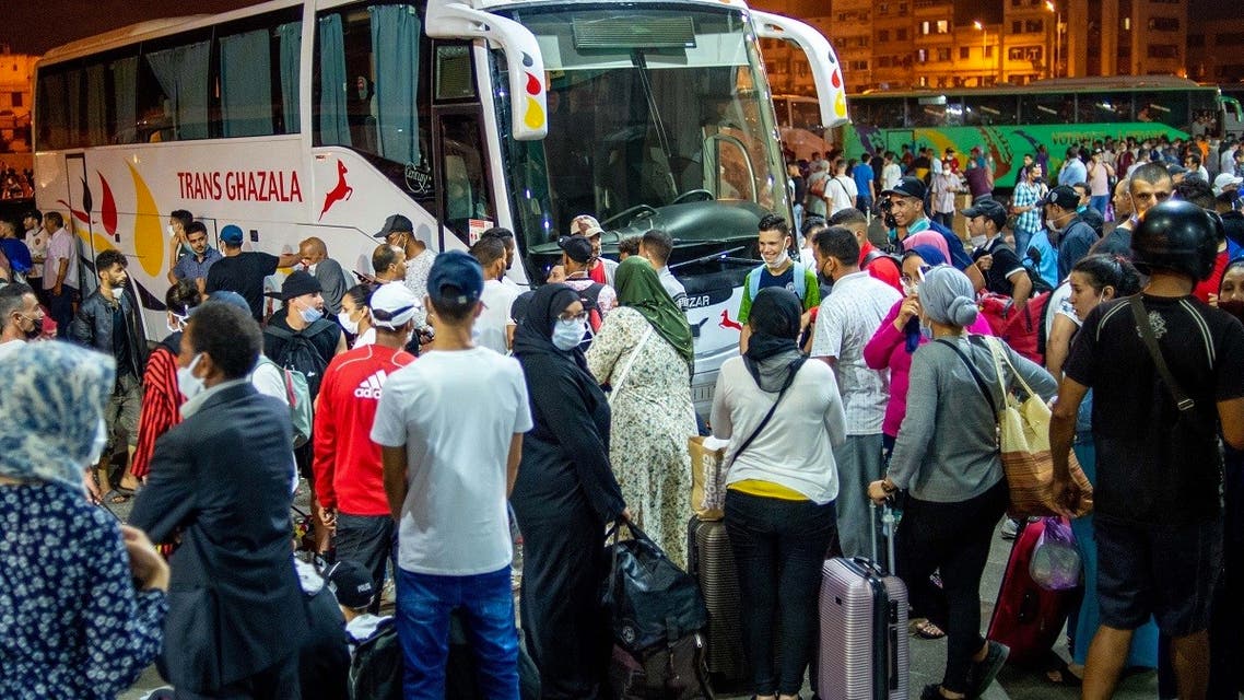 Moroccans gather in the “Ouled Ziane” bus station in Casablanca on July 26 ,2020 to leave the city before travel restrictions imposed by authorities to smother a new outbreak of the novel coronavirus. (AFP)