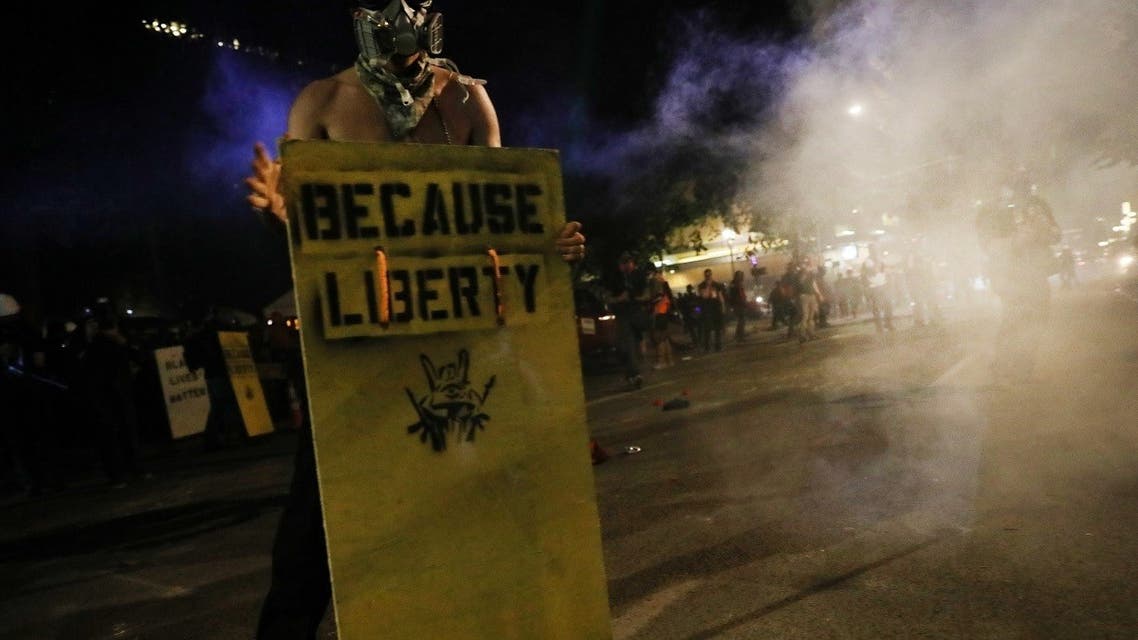 People gather in protest in front of the Mark O. Hatfield federal courthouse in downtown Portland as the city experiences another night of unrest on July 26, 2020 in Portland, Oregon. (AFP)
