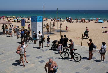 People queue to enter the beach, after Catalonia’s regional authorities and the city council announced restrictions to contain the spread of the coronavirus in Barcelona, Spain, on July 19, 2020. (Reuters)