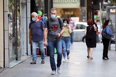 People walk as they wear face masks to prevent the spread of the coronavirus disease (COVID-19) in Beirut, Lebanon. (Reuters)