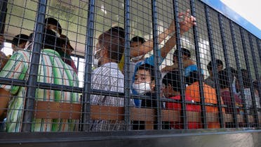 Suspected Uighurs are transported back to a detention facility in the town of Songkhla in southern Thailand after visiting women and children at a separate shelter on March 26, 2014. (Reuters)