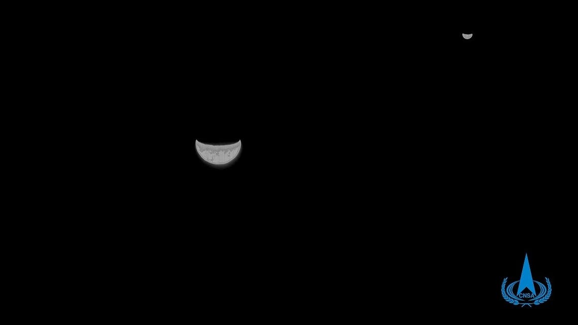 This handout photograph taken on July 27, 2020 and released by the China National Space Administration via CNS, shows a view of the Earth and Moon taken by China's Tianwen-1 Mars probe from a distance of 1.2 million kilometers. (AFP)