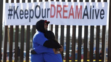 'Dreamers' hug as they meet with relatives during the 'Keep Our Dream Alive' binational meeting at a new section of the border wall on the U.S.-Mexico border in Sunland Park, U.S., opposite the Mexican city of Ciudad Juarez, Mexico, December 10, 2017. (Reuters)
