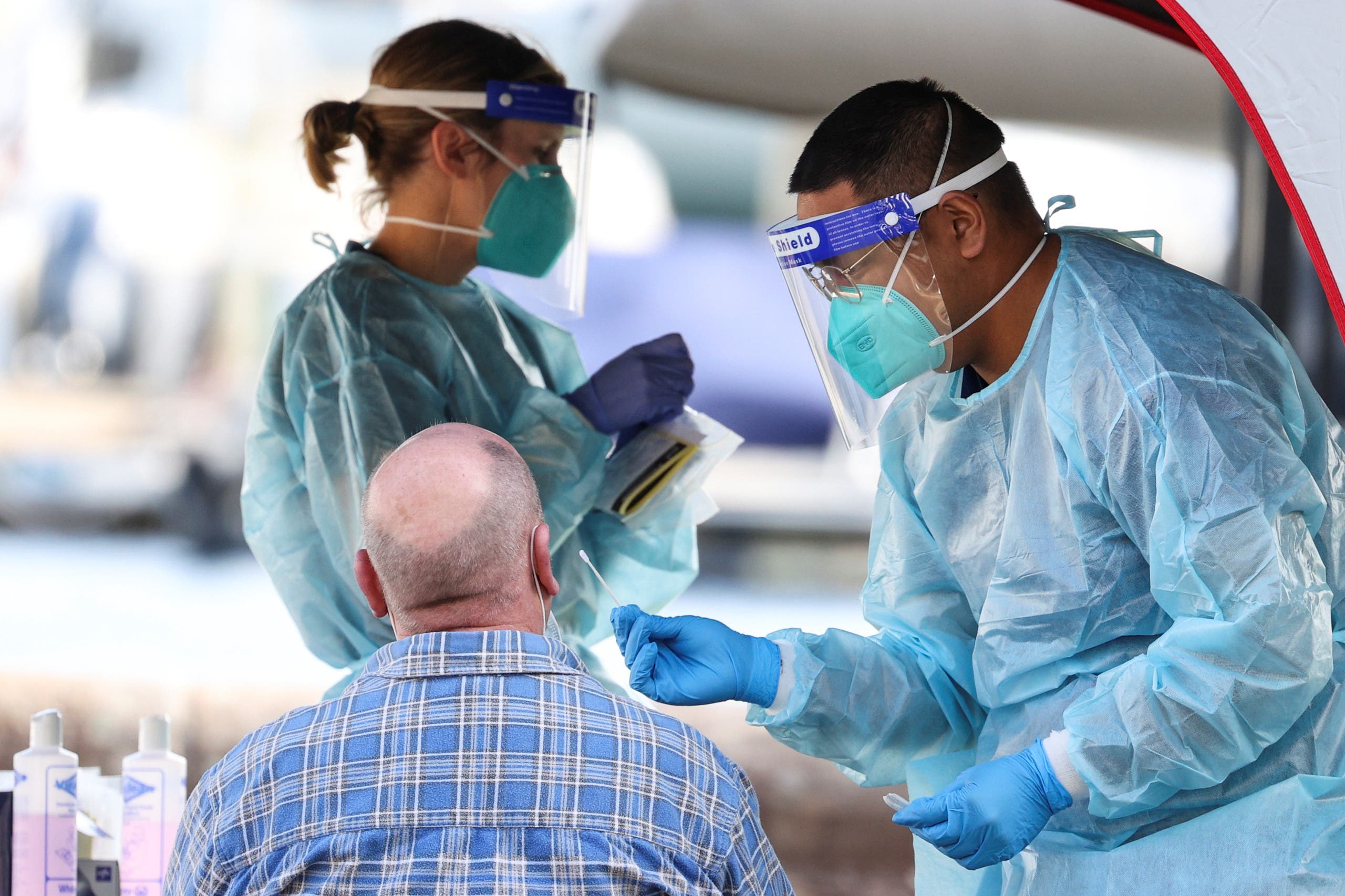 A medical personnel holds a swab while administering a test for the coronavirus disease (COVID-19) at a pop-up testing centre, as the state of New South Wales grapples with an outbreak of new cases, in Sydney, Australia. (Reuters)