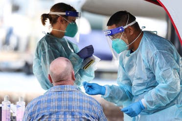 A medical personnel holds a swab while administering a test for the coronavirus disease (COVID-19) at a pop-up testing centre, as the state of New South Wales grapples with an outbreak of new cases, in Sydney, Australia. (Reuters)