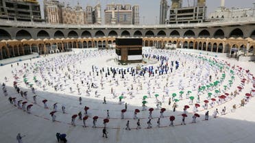 A picture taken on July 29, 2020 shows pilgrims while social distancing as a coronavirus preventative measure while circumambulating around the Kaaba, Islam's holiest shrine, at the centre of the Grand Mosque in the holy city of Mecca, at the start of the annual Muslim Hajj pilgrimage. (AFP)