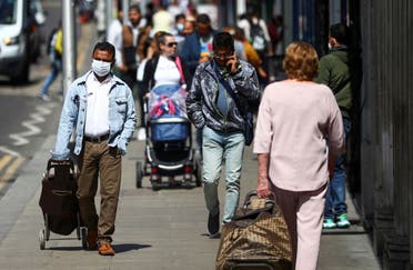 People walk down a street following the coronavirus disease (COVID-19) outbreak, in Ilford, London, Britain July 29, 2020. (Reuters)