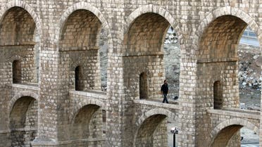 A man walks under the Ten Bridges in Amman, Jordan, a structure part of the Hijaz Railway, which the Ottoman started building in 1908. (AP)