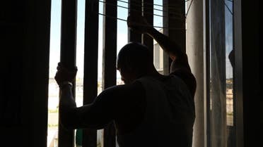 A prisoner stands in his cell in the Poissy prison, specialised in long sentences, August 14, 2019, in Poissy, west of Paris, France. (AFP)