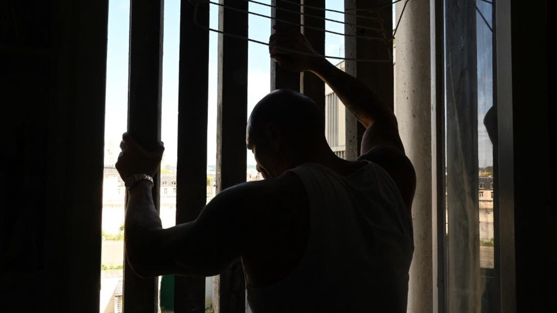 A prisoner stands in his cell in the Poissy prison, specialised in long sentences, August 14, 2019, in Poissy, west of Paris, France. (AFP)
