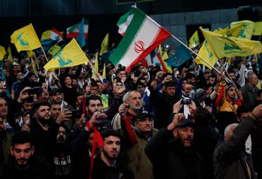 Hezbollah supporters shout slogans and wave Lebanese, Hezbollah and Iran flags, during a rally to commemorate the 40th anniversary of Iran's Islamic Revolution, in southern Beirut, Lebanon, Wednesday, Feb. 6, 2019. (AP)
