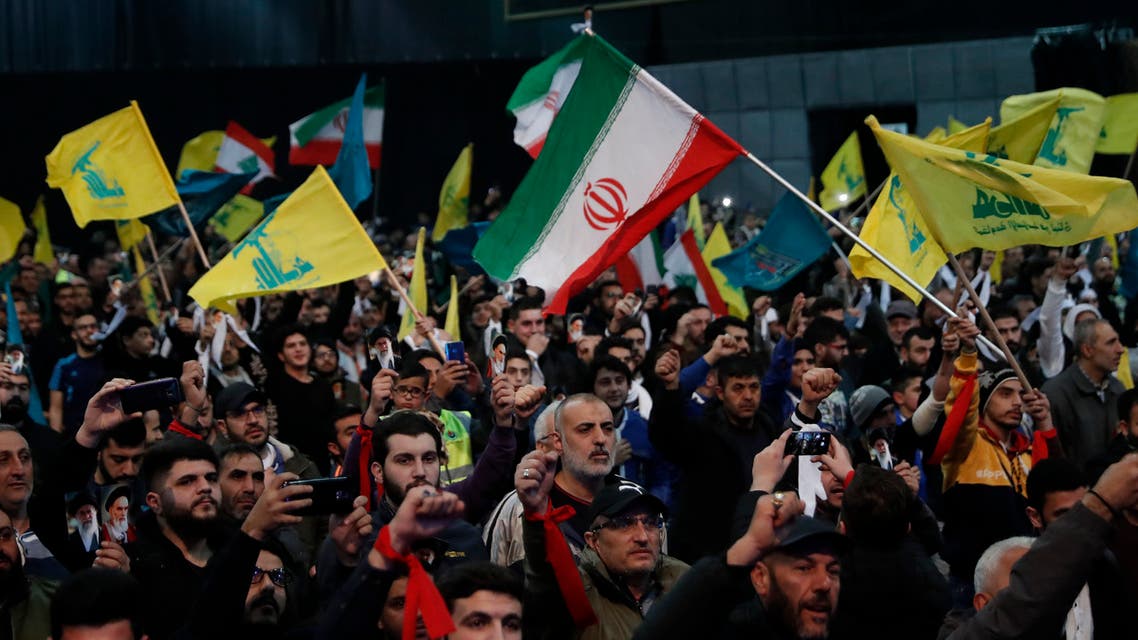 Hezbollah supporters shout slogans and wave Lebanese, Hezbollah and Iran flags, during a rally to commemorate the 40th anniversary of Iran's Islamic Revolution, in southern Beirut, Lebanon, Wednesday, Feb. 6, 2019. (AP)