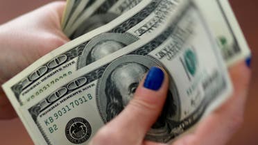A woman counts U.S. dollar bills. (File photo: Reuters)